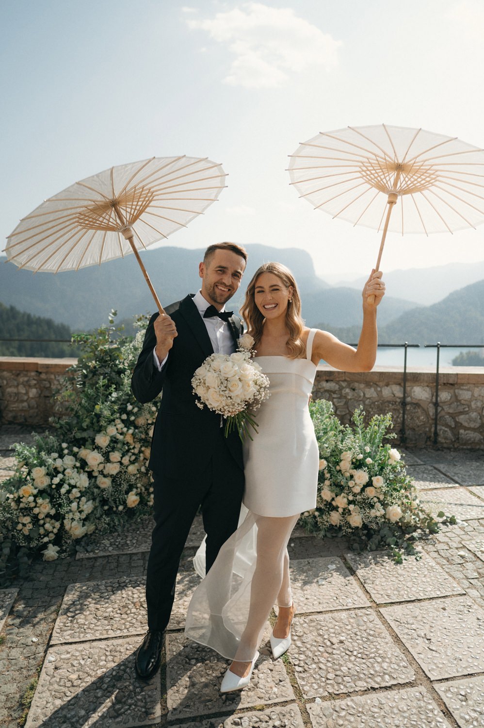 bride and groom married at castle bled with sun umbrellas