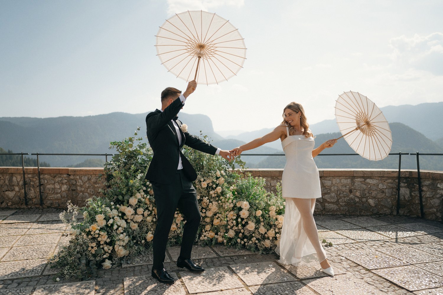 bride and groom married at castle bled with sun umbrellas